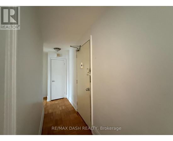 A hallway with a door at the end.