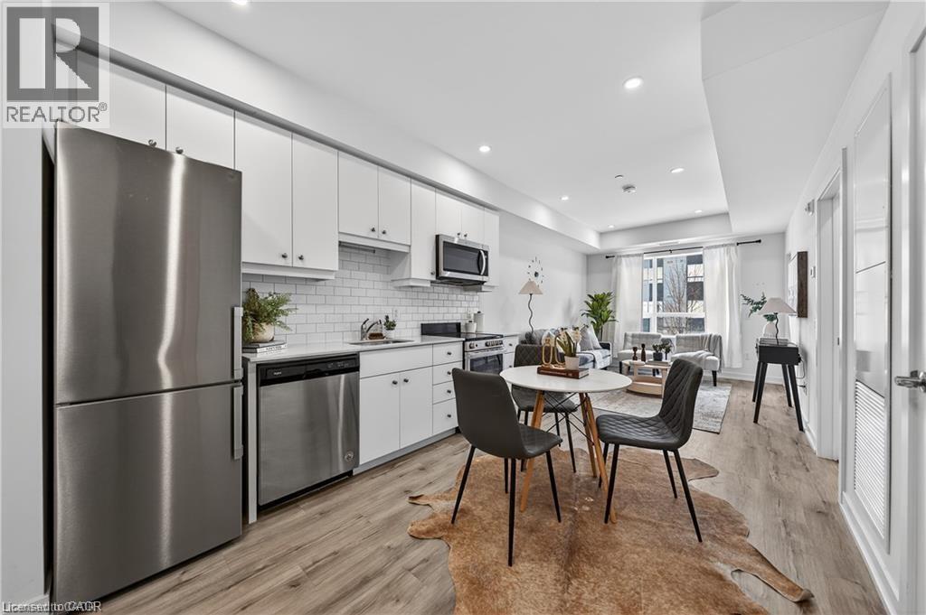 A modern kitchen with a dining table and chairs.