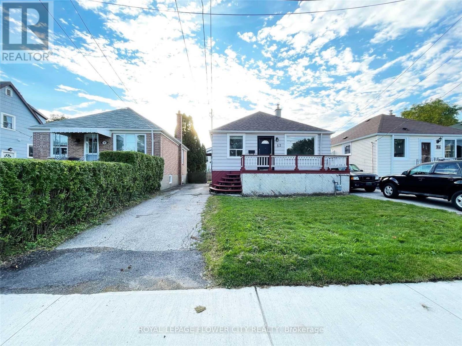 A residential area with houses and a car parked in front of one.