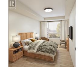 A bedroom with a bed, nightstand, and chair.