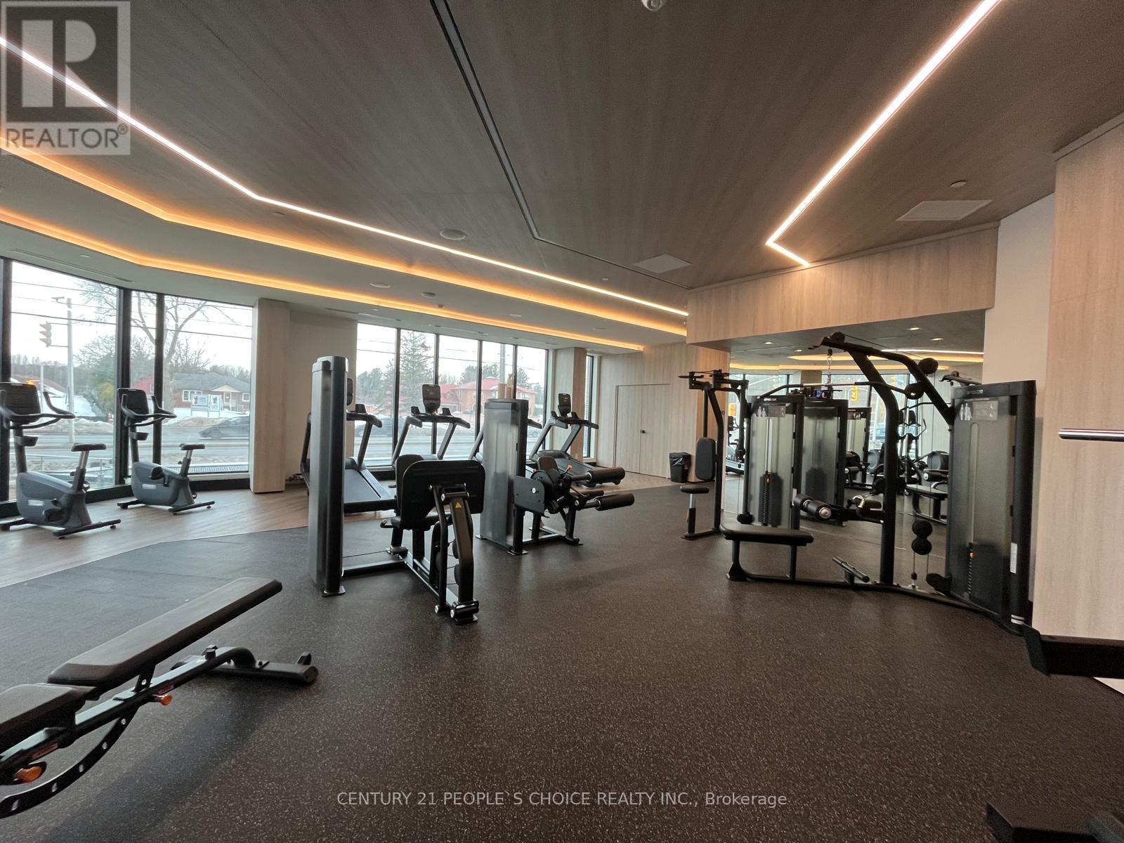 A gym with a variety of equipment including treadmills, weights, and exercise machines.