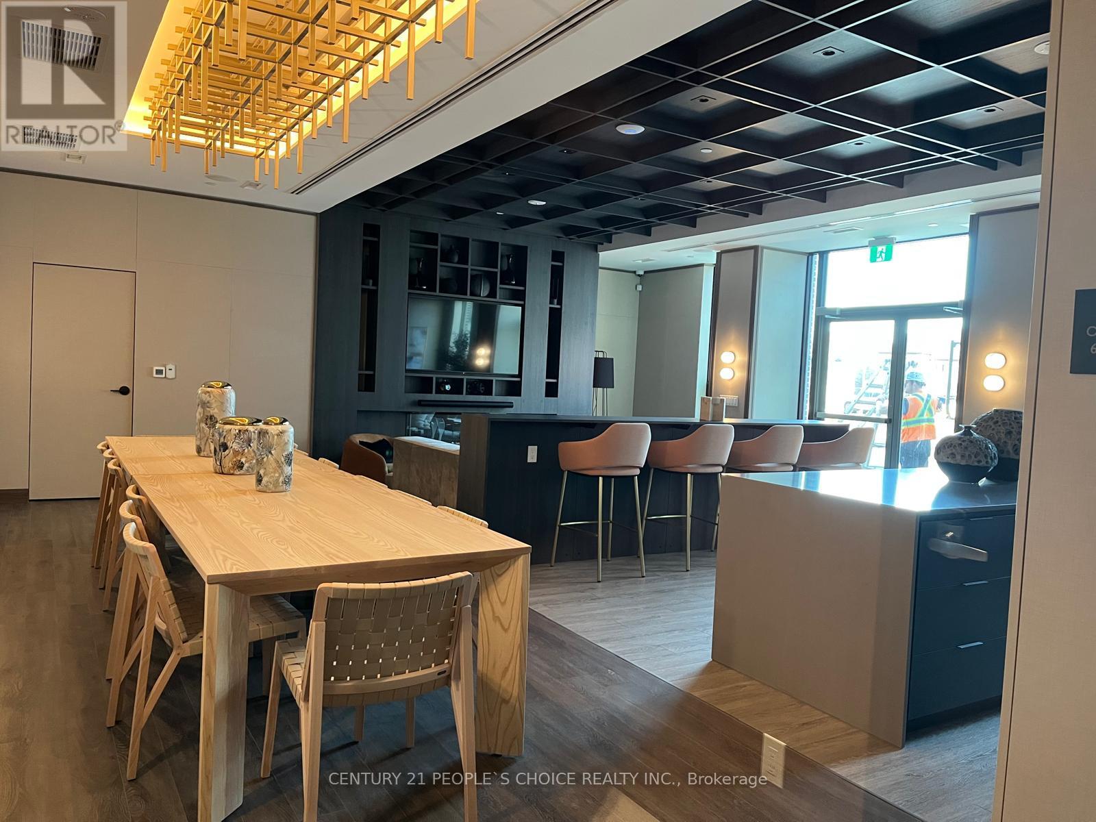 A dining room with a wooden table and chairs.