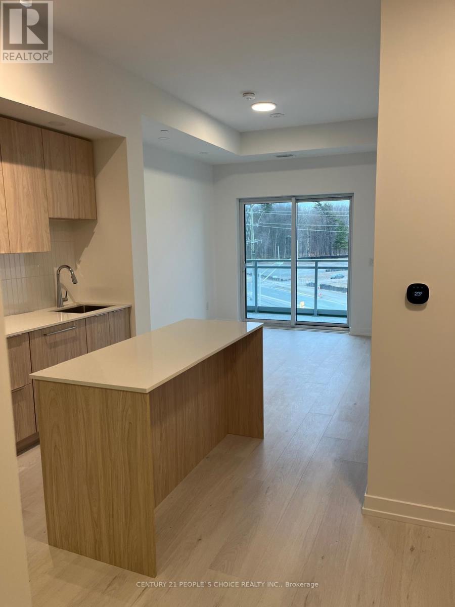 A kitchen with wooden cabinets and a countertop is shown.