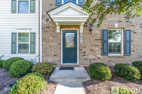 A house with a white front and a green door.