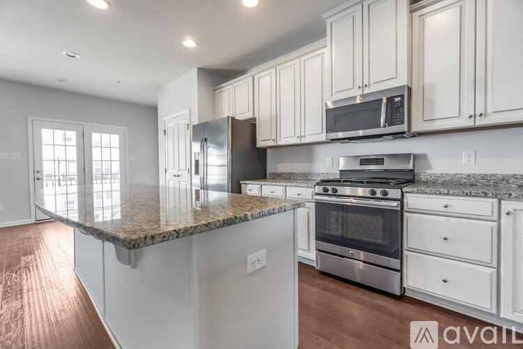 A kitchen with granite countertops and stainless steel appliances.
