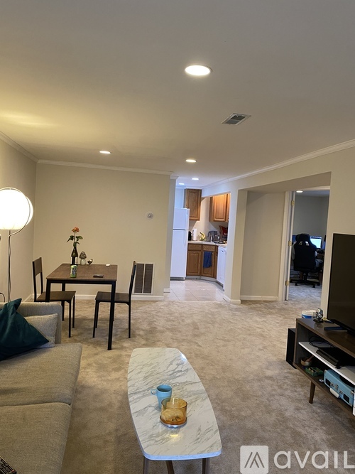 A living room with a couch, coffee table, and television.