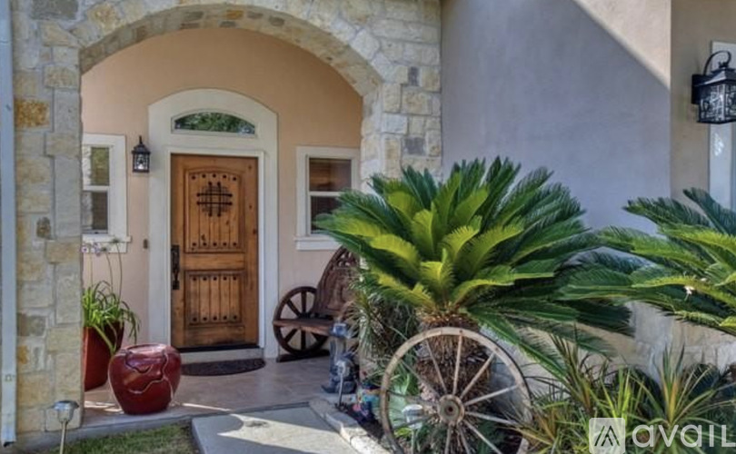 A house entrance with a wooden door and a stone archway.