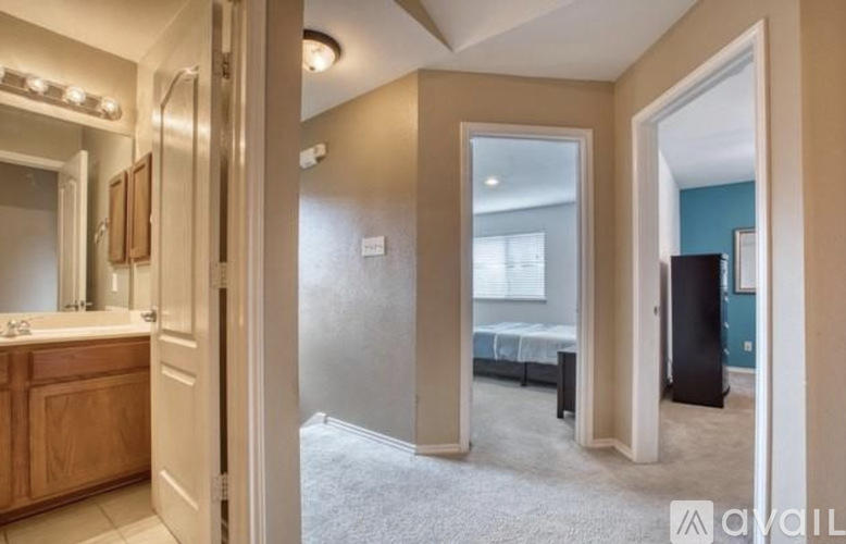 A bedroom with a mirror, a bed, and a dresser.