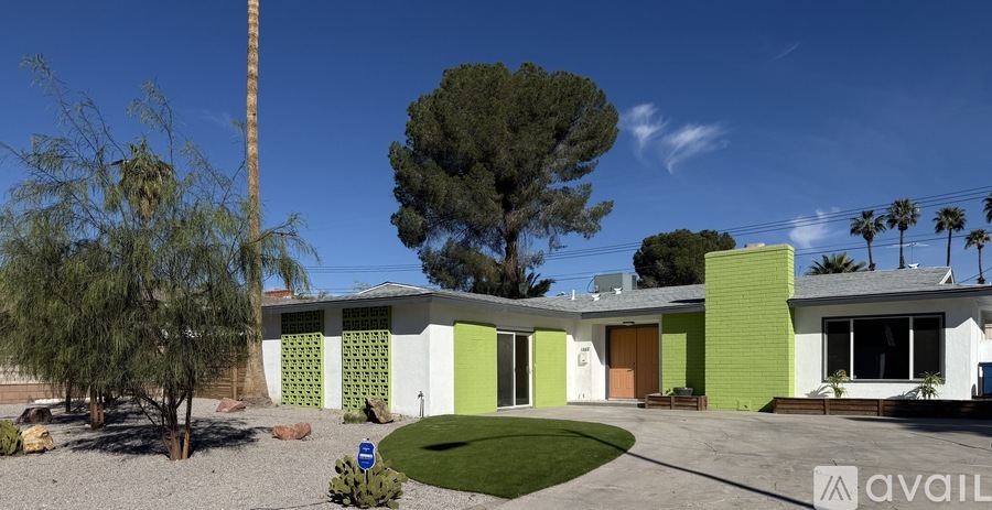 A house with a green and white exterior is for sale.