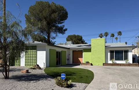 A house with a green and white exterior is for sale.
