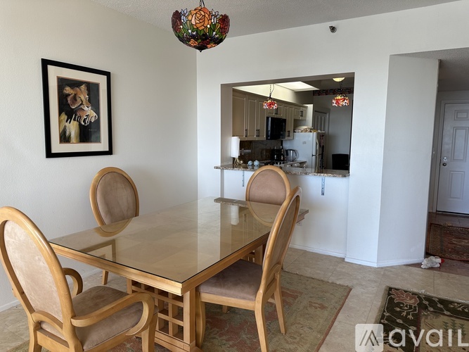 A dining room with a table and chairs.