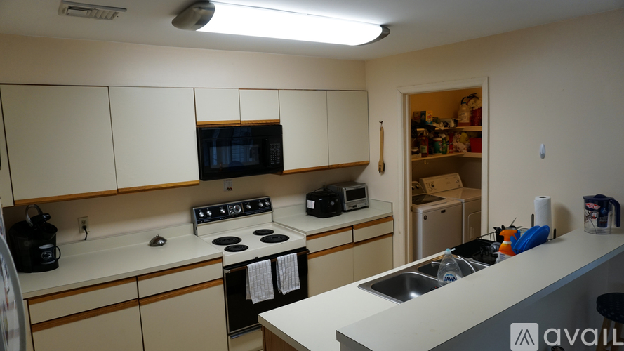 A kitchen with a stove, microwave, and oven.