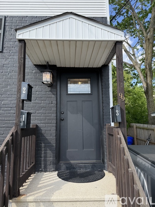 A black door is on the front of a house.