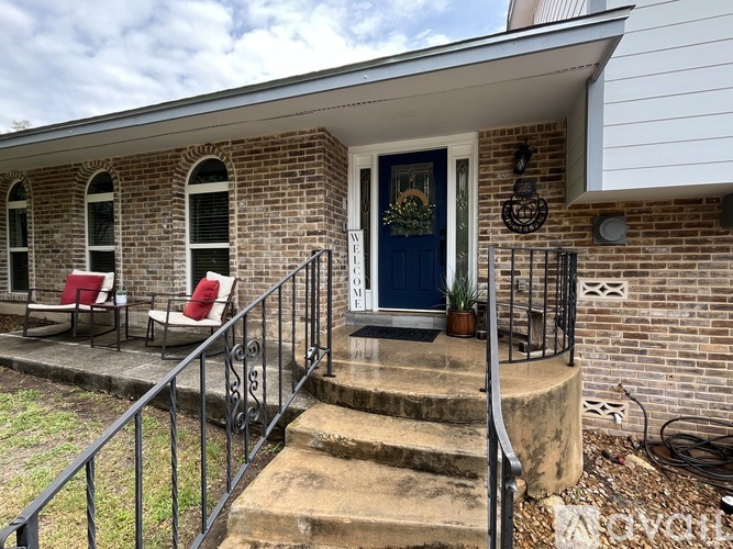 A house with a blue door and a wreath on it.