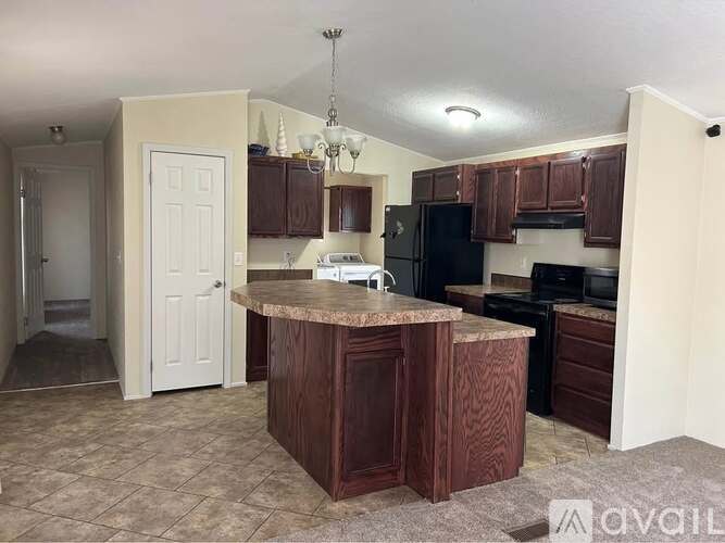 A kitchen with brown cabinets and a granite countertop.
