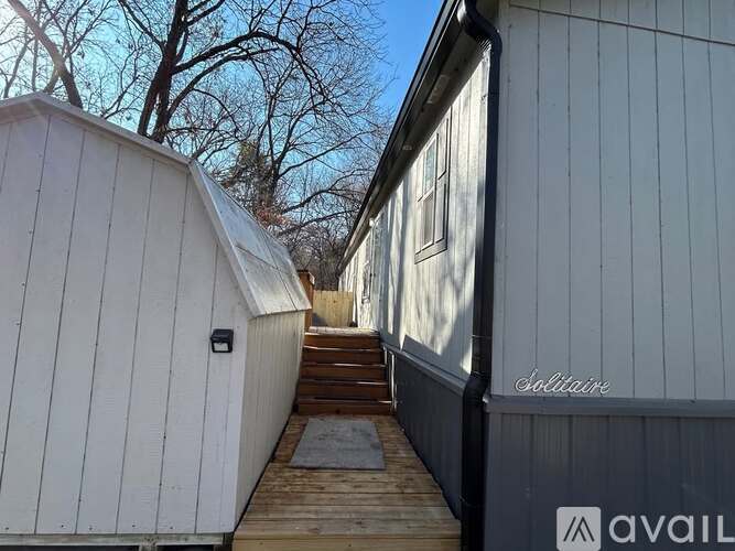 A wooden deck leads to a white building with a sign that says "Sobriette" on the side.