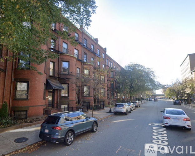 A street view of a residential area with cars parked on the side of the road.