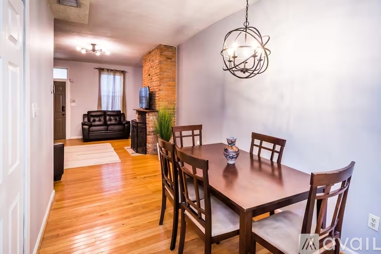 A dining room with a wooden table and chairs.