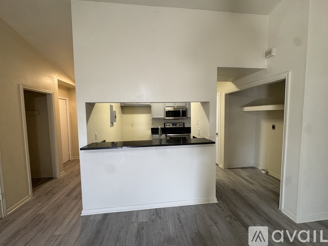 A modern kitchen with a white countertop and a stainless steel oven.