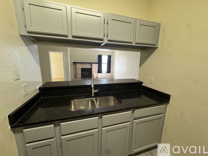 A kitchen with a sink and cabinets.