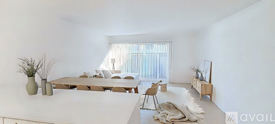 A modern living room with a large table and chairs.