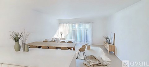 A modern living room with a large table and chairs.