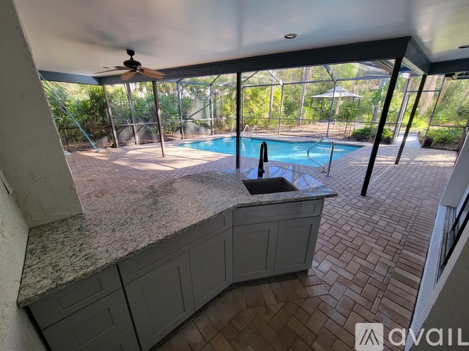 A patio with a pool and a fan.