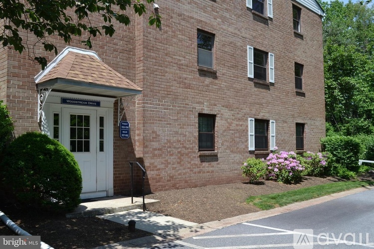 A building with a white door and windows with shutters.