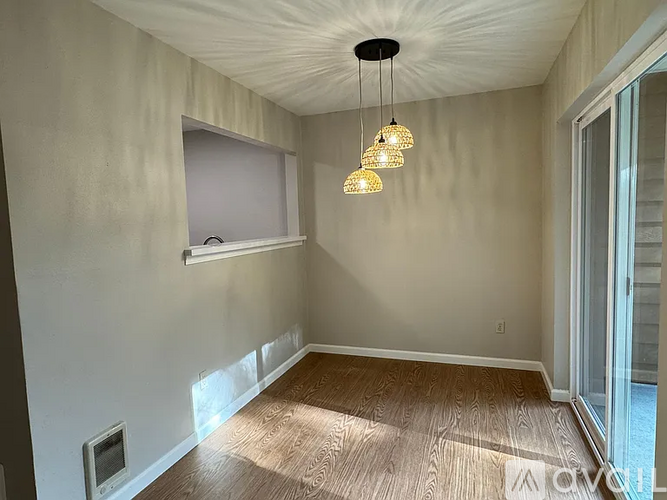 A room with a window and a light fixture.