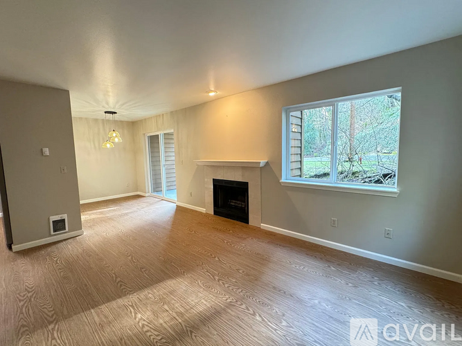 A living room with a fireplace and a window.