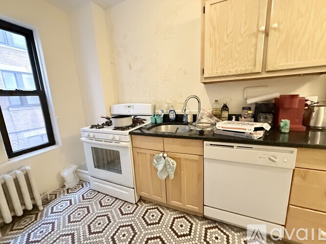 A kitchen with white appliances and wooden cabinets.