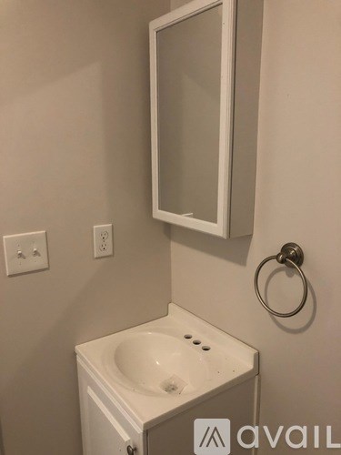 A white sink in a small bathroom.