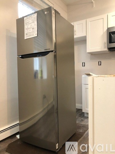 A stainless steel refrigerator with a paper on it.