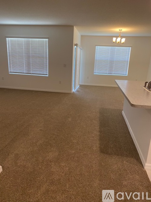 A room with brown carpet and white walls.