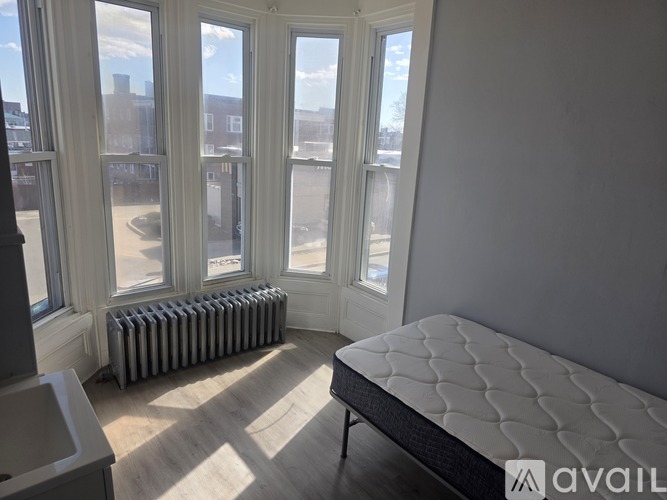 A bedroom with a large bed and a radiator.