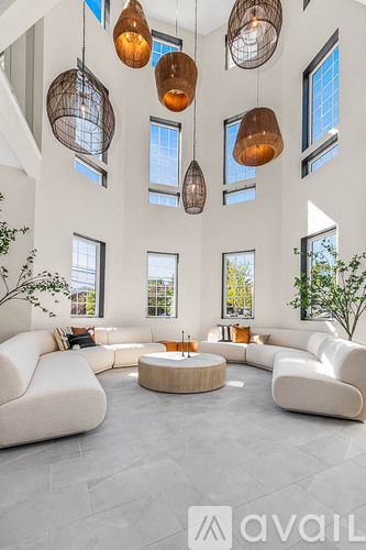 A modern living room with a circular coffee table and white sofas.