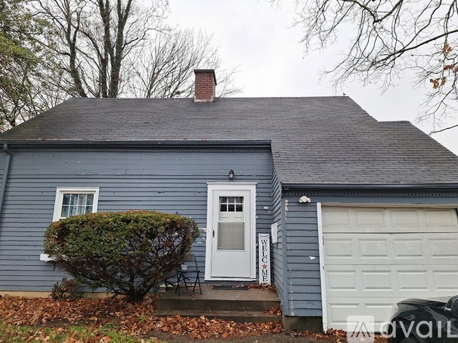 A house with a white door and a garage door.