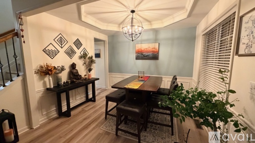 A dining room with a wooden table and chairs.