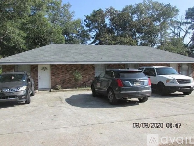 A house with a car parked in front of it.