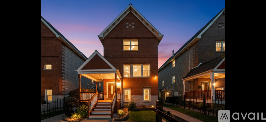 A house with a front yard and a porch is lit up at dusk.