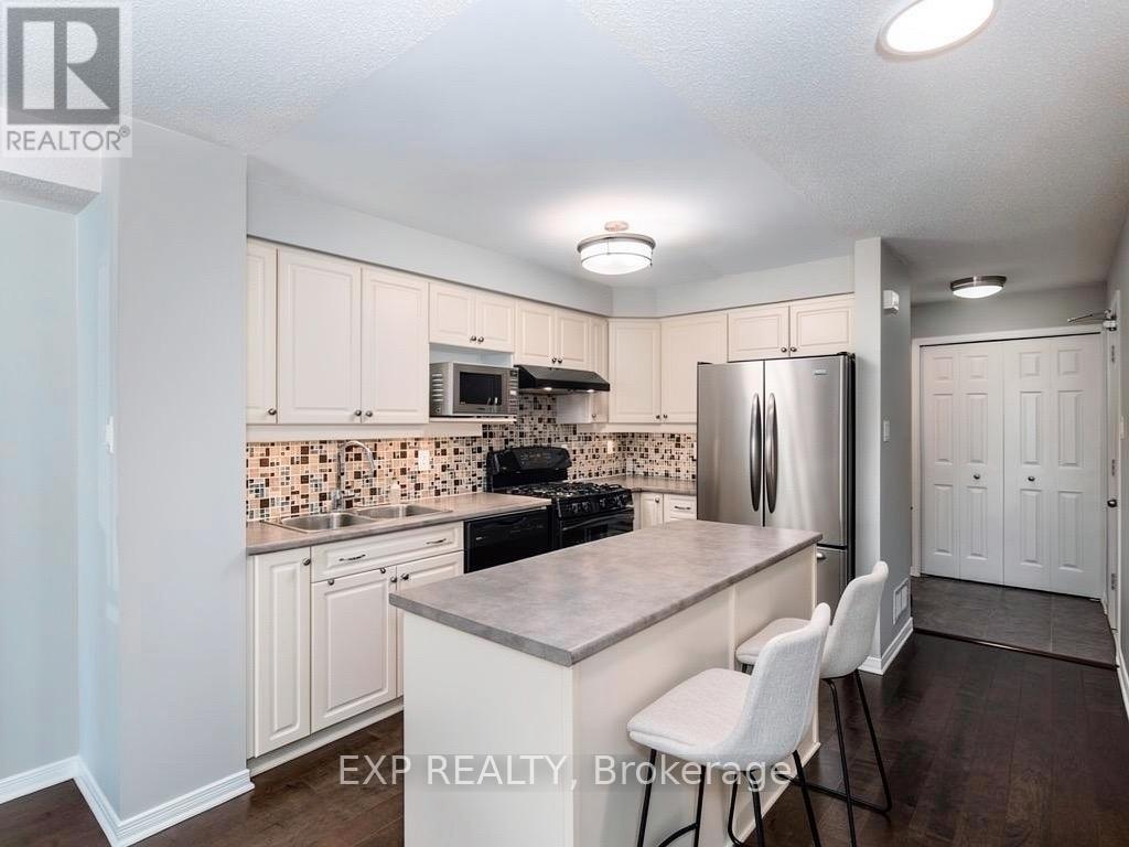 A kitchen with white cabinets and a tile backsplash.