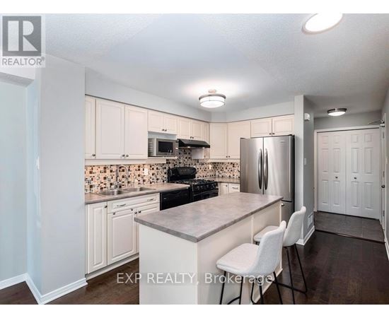 A kitchen with white cabinets and a tile backsplash.