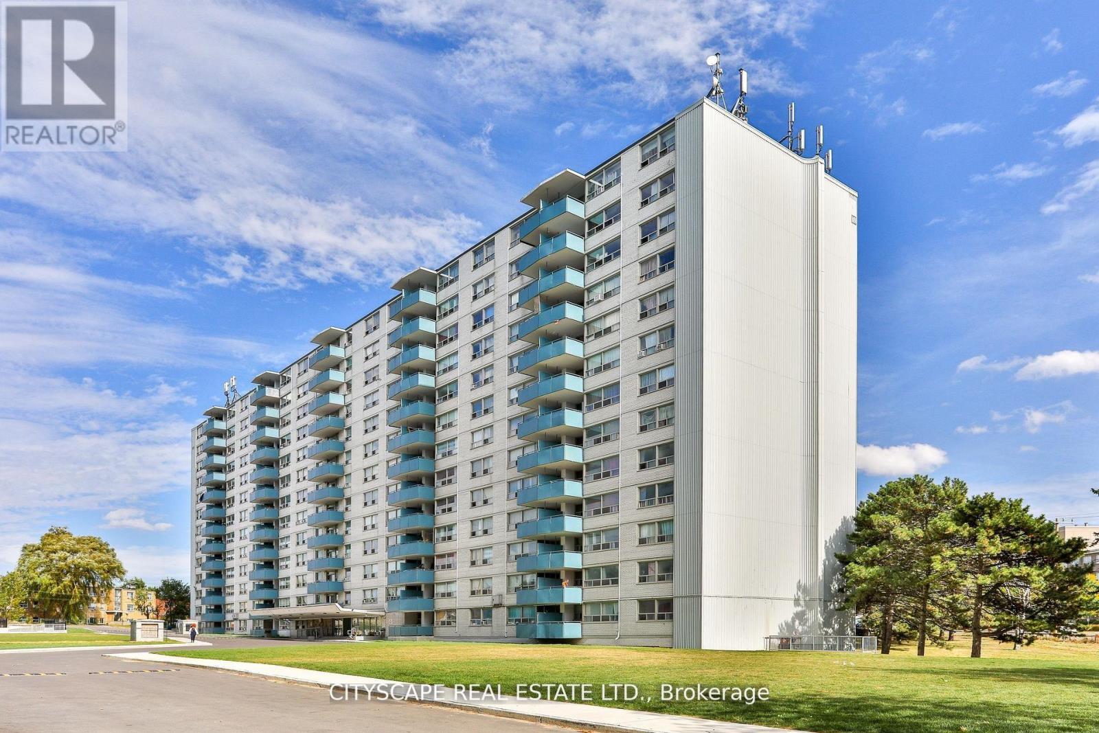 A tall residential building with a clear blue sky in the background.