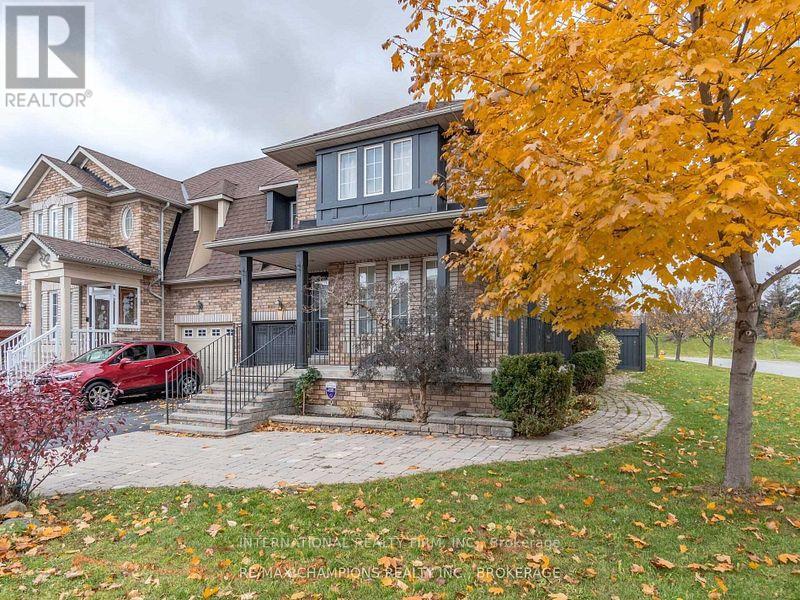 A house with a red car parked in front of it.