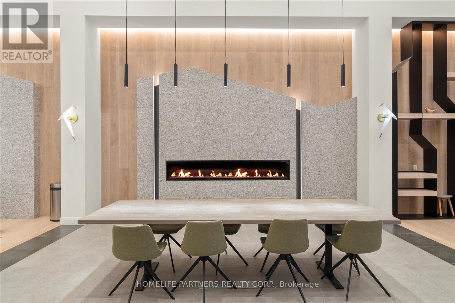 A modern dining room with a fireplace and chairs.
