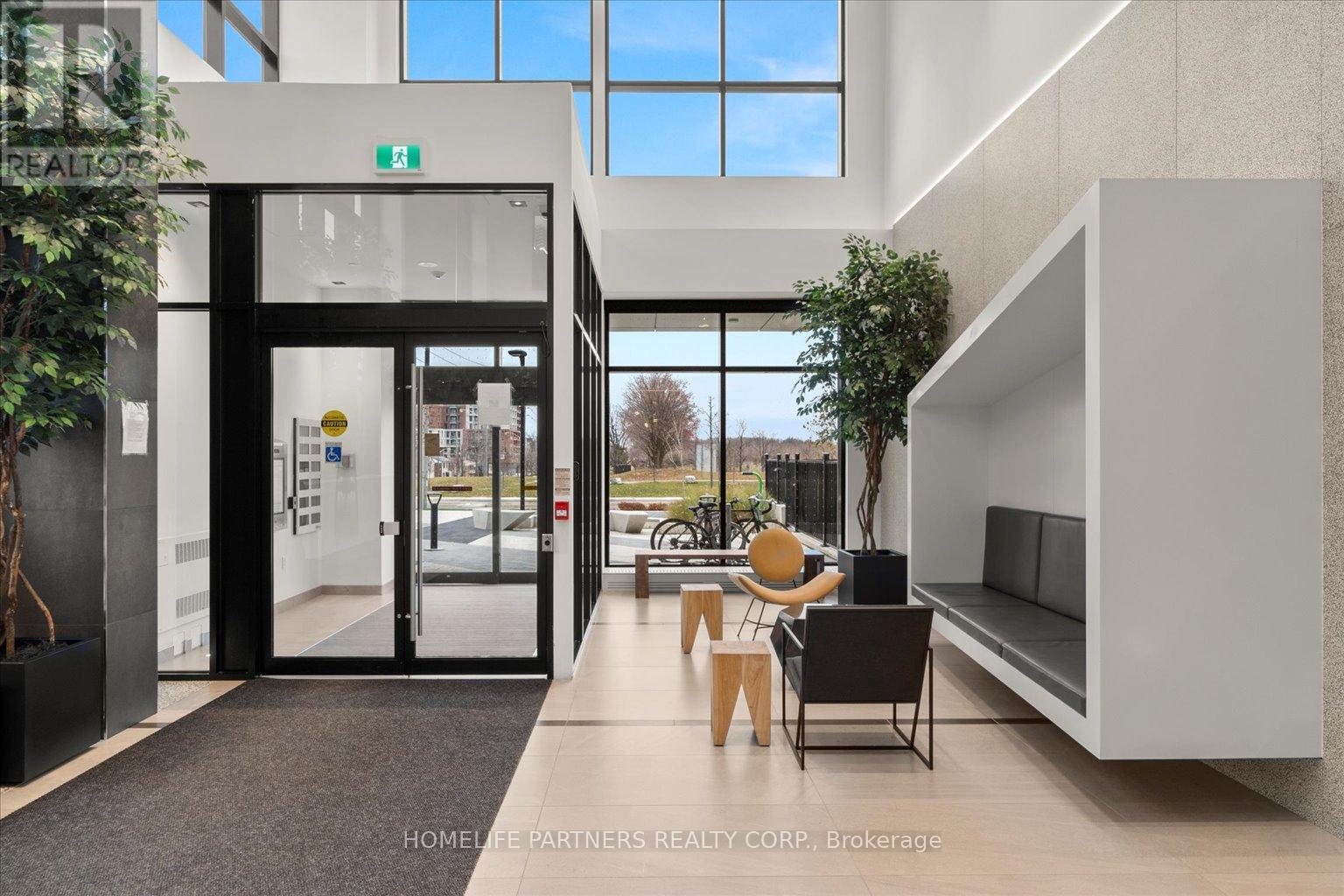 A modern interior space with a reception desk and seating area.