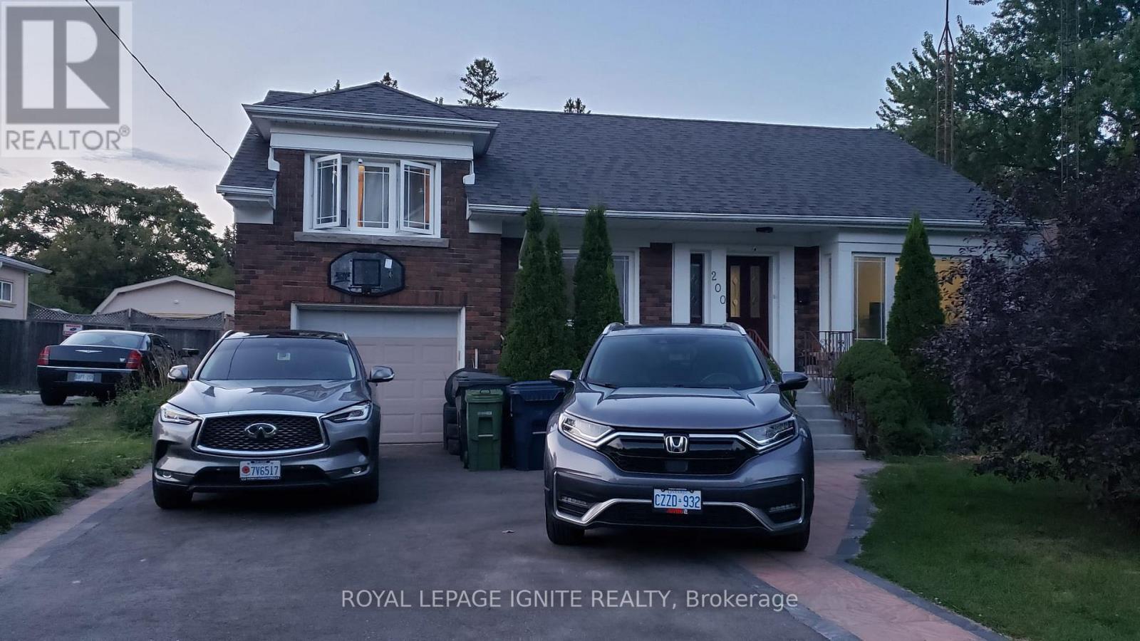 Two cars are parked in front of a house with the text "ROYAL LEPAGE IGNITE REALTY, Brokerage" on the image.