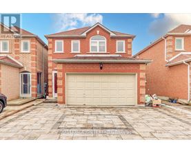A large red brick house with a white garage door in front.