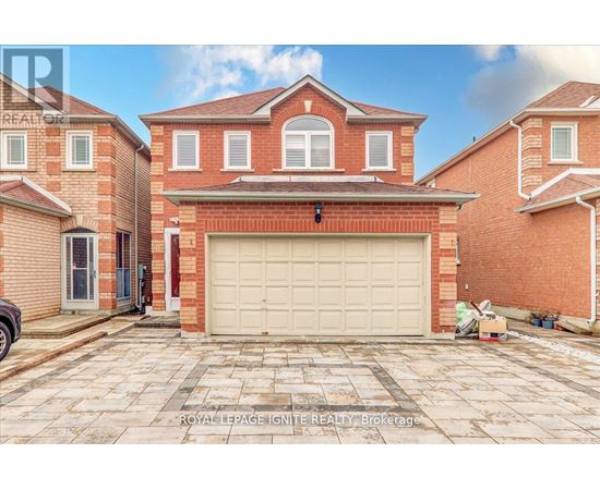 A large red brick house with a white garage door in front.