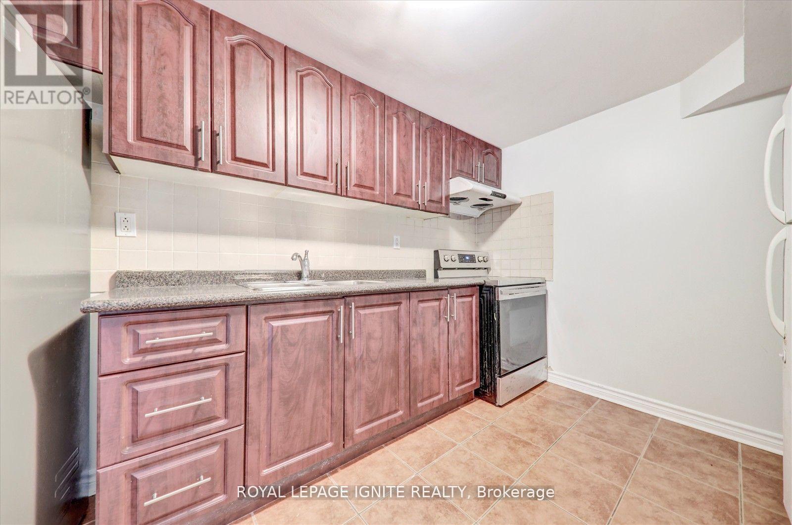 A kitchen with brown cabinets and a stainless steel dishwasher.